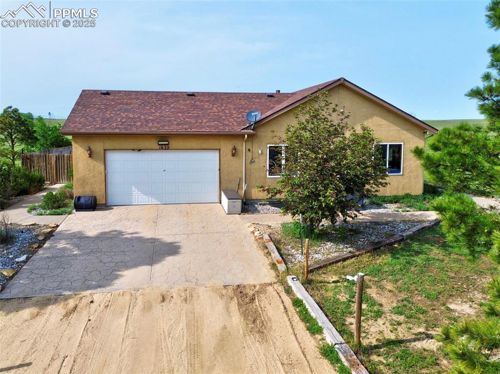 1625 North Yoder Road Yoder, CO 80864 - Photo 3 of 50 a front view of a house with garden