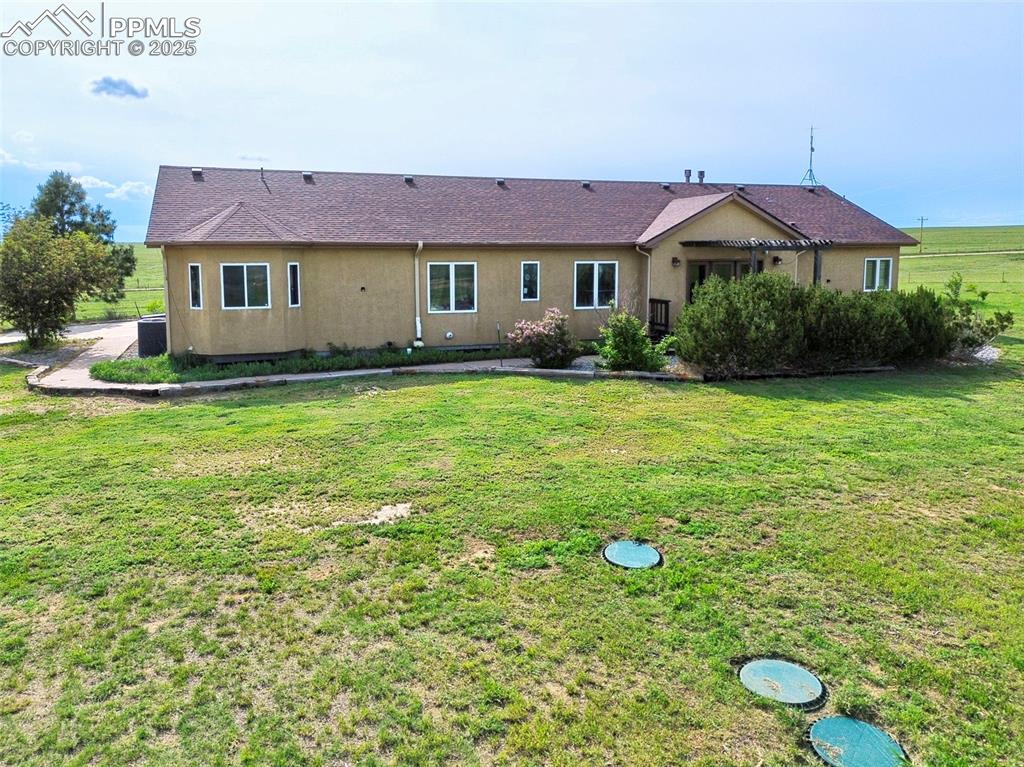 1625 North Yoder Road Yoder, CO 80864 - Photo 36 of 50 a view of a house with a yard and sitting area