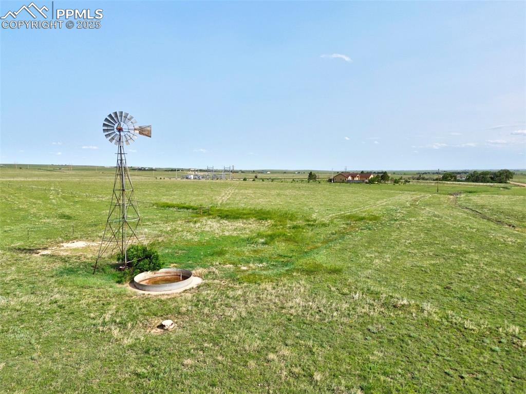 1625 North Yoder Road Yoder, CO 80864 - Photo 41 of 50 Pasture with Windmill and Water Tank