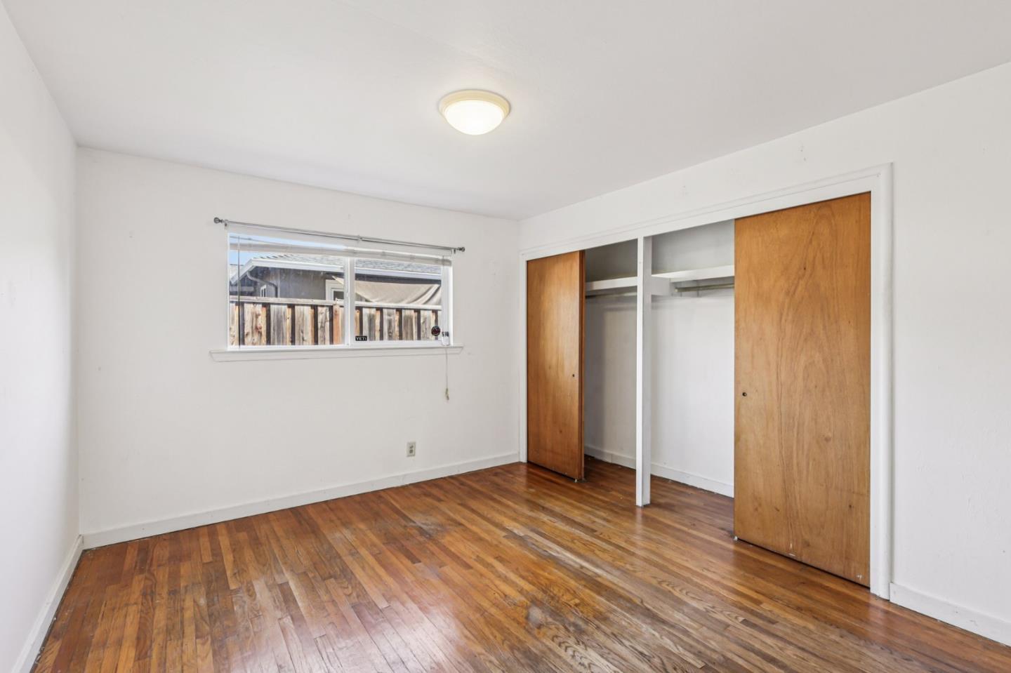 320 Coelho Street Milpitas, CA 95035 - Photo 18 of 34 an empty room with wooden floor and a window