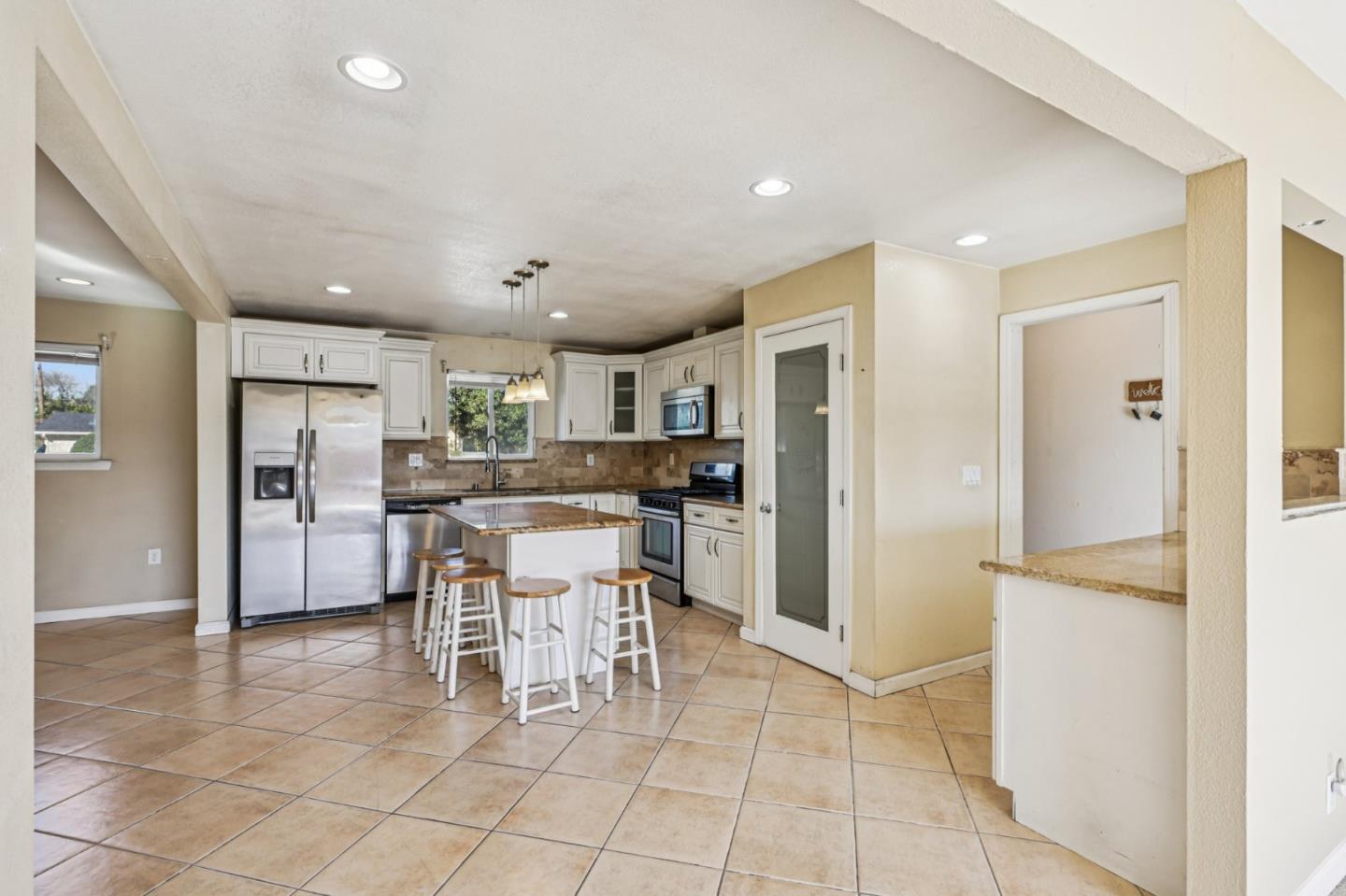 320 Coelho Street Milpitas, CA 95035 - Photo 7 of 34 a kitchen with stainless steel appliances kitchen island granite countertop a refrigerator and a sink