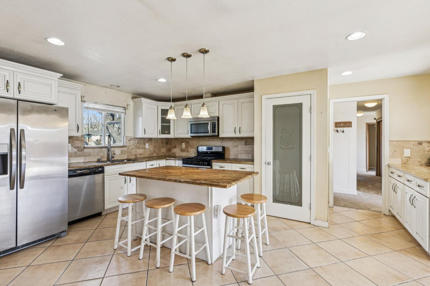 320 Coelho Street Milpitas, CA 95035 - Photo 8 of 34 a kitchen with stainless steel appliances granite countertop a refrigerator and a stove top oven
