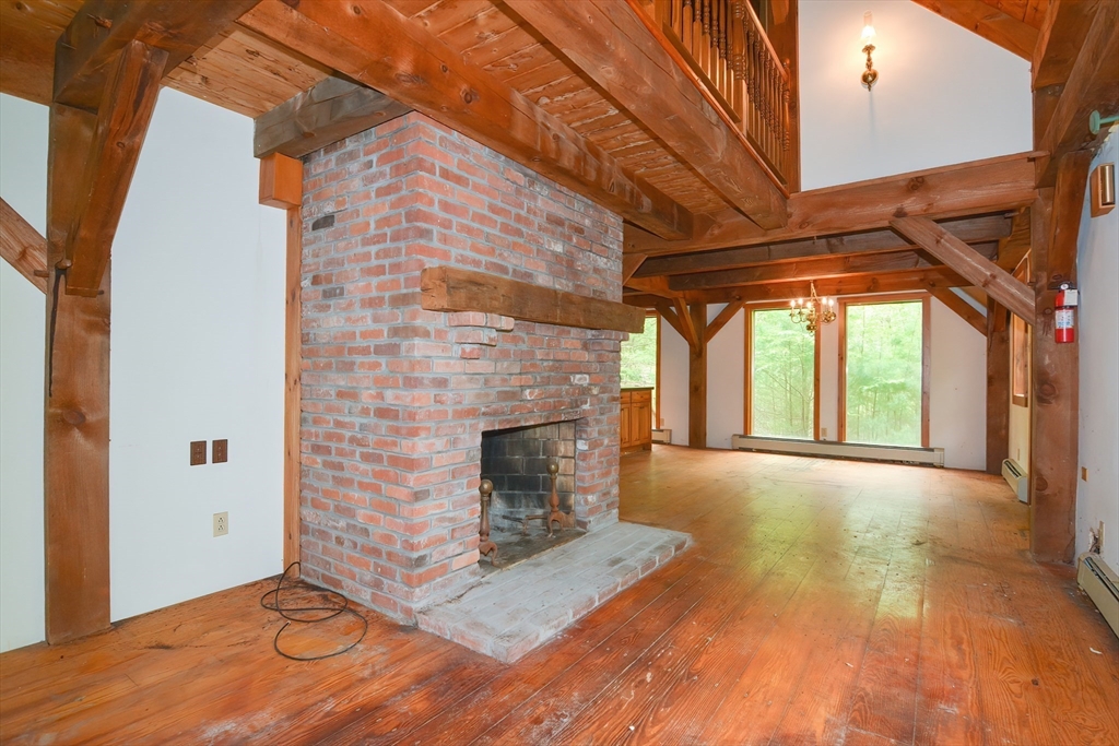 317 Fowler Road Northbridge, MA 01534 - Photo 12 of 40 a view of empty room with wooden floor and fireplace