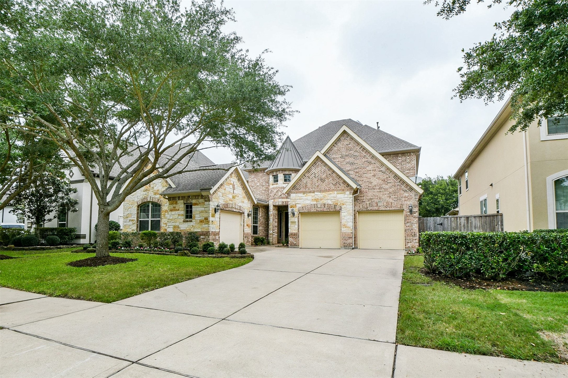 24914 Bay Mist Ridge Lane Katy, TX 77494 - Photo 3 of 50 At any time of day or night, this incredible gem, at 24914 Bay Mist Ridge Lane, Katy, TX, in the quiet, 34-home Cinco Ranch Southwest community, displays magnificent curb appeal. Inside this single family, 2-story treasure are 4 bedrooms and 3-1/2 baths, all gracing an 8,186 square-foot-lot with 4,401 square-feet of interior living space. Seen here, atop a roomy driveway, are 3 attached garages. Also, note the meticulously maintained landscaping and native greenery.