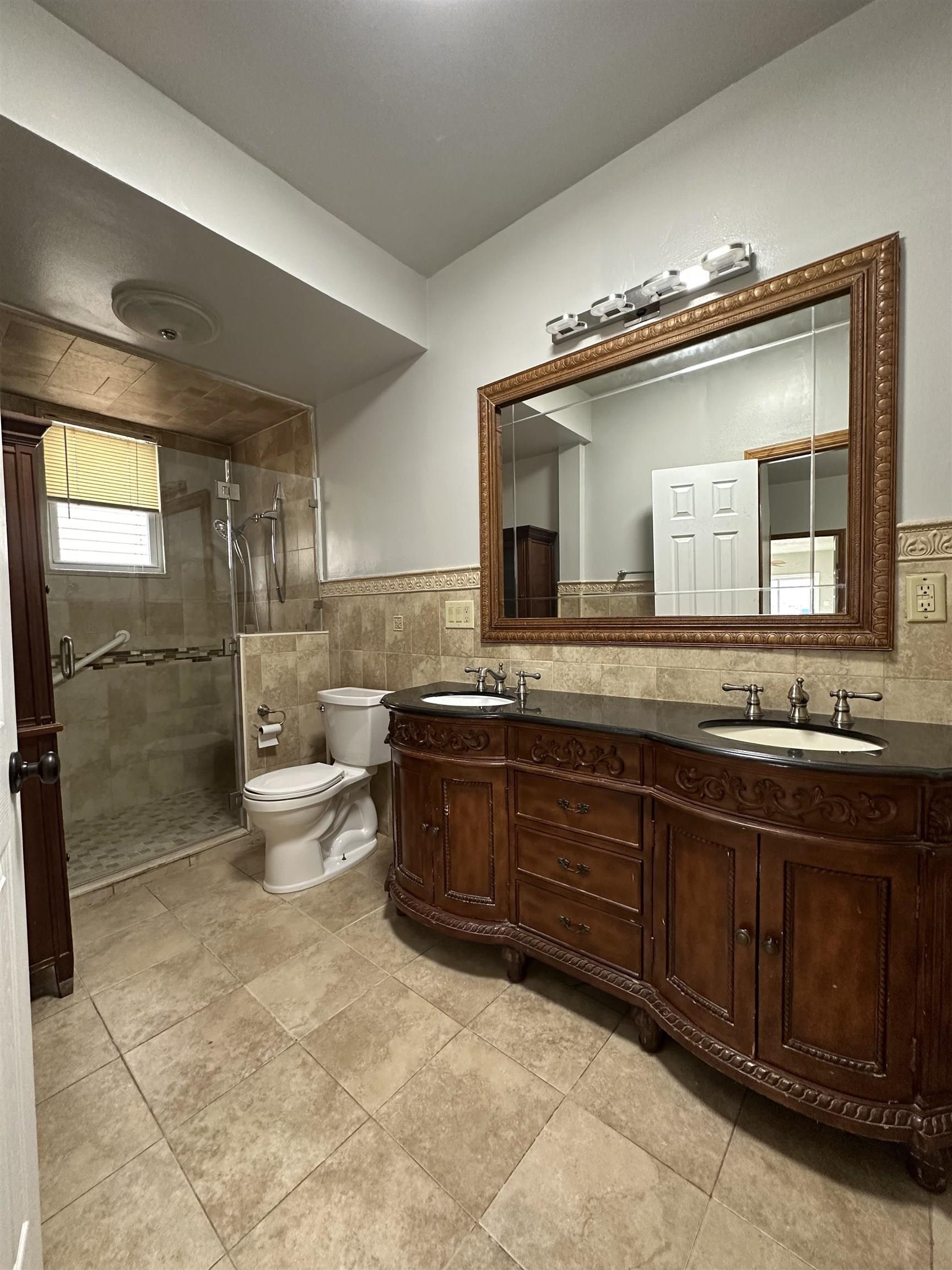172 West 25th Street, Unit 2 Bayonne, NJ 07002 - Photo 11 of 11 a bathroom with a granite countertop sink mirror and toilet