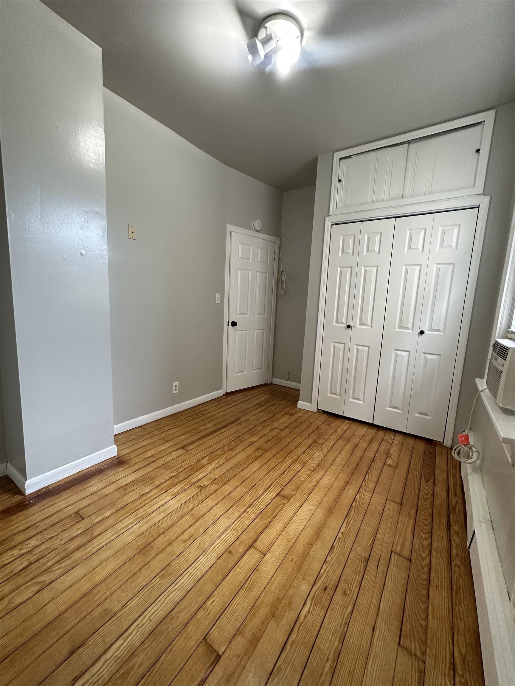 172 West 25th Street, Unit 2 Bayonne, NJ 07002 - Photo 6 of 11 a view of empty room with wooden floor