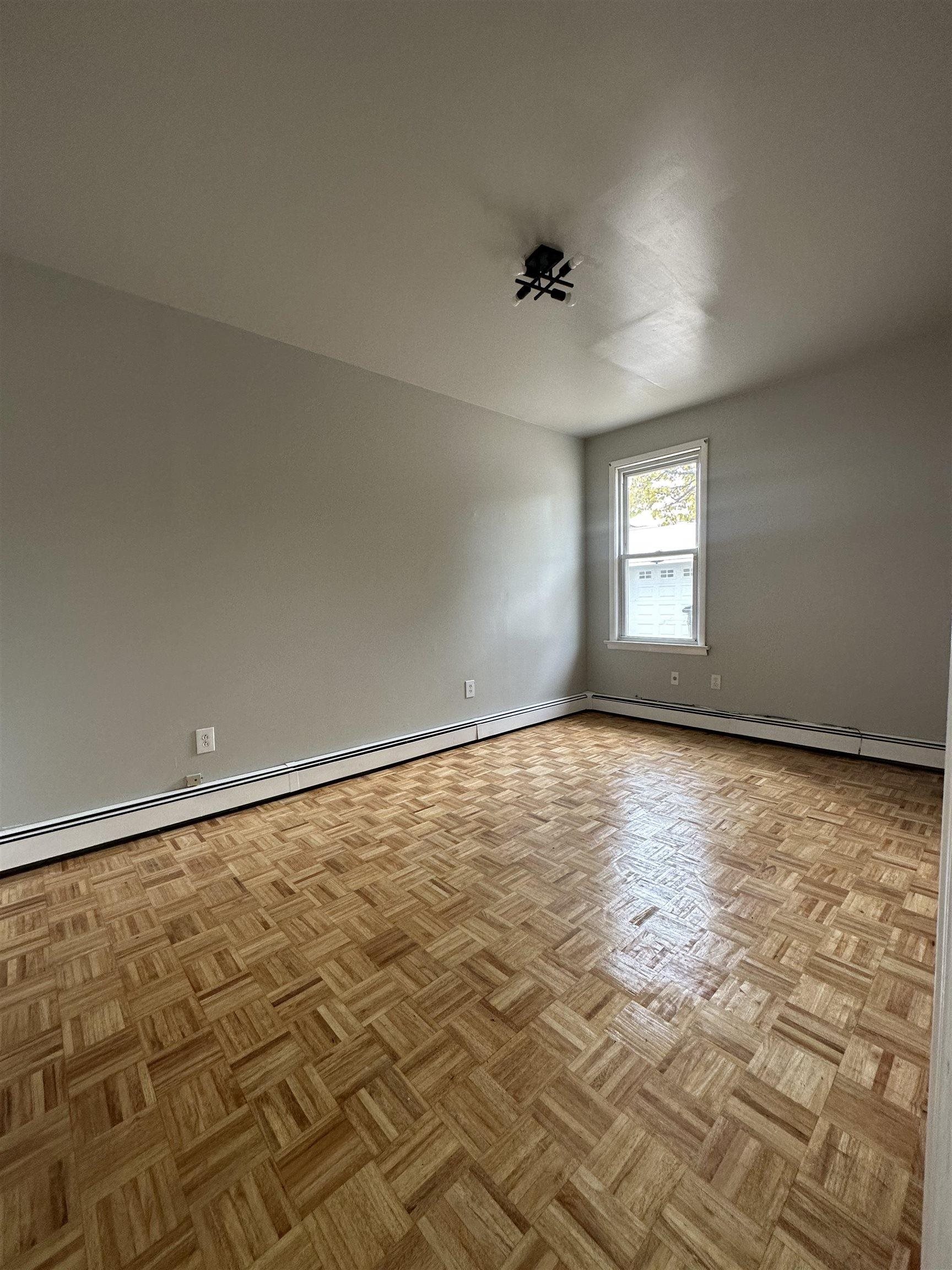 172 West 25th Street, Unit 2 Bayonne, NJ 07002 - Photo 9 of 11 a view of an empty room and window