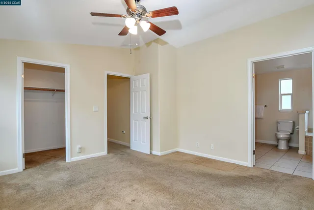 a view of an empty room and a bathroom