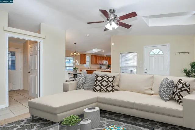 a living room with furniture and a chandelier