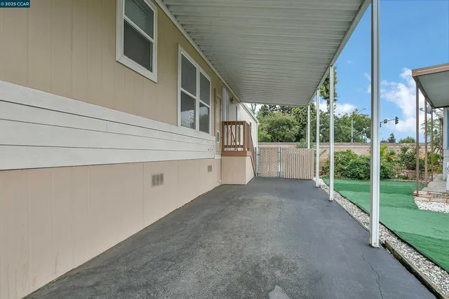 a view of a house with a backyard and floor to ceiling window