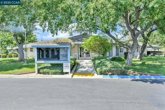 a view of house with outdoor space and swimming pool