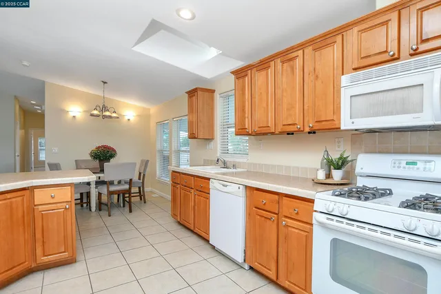 a kitchen with a stove a sink and cabinets