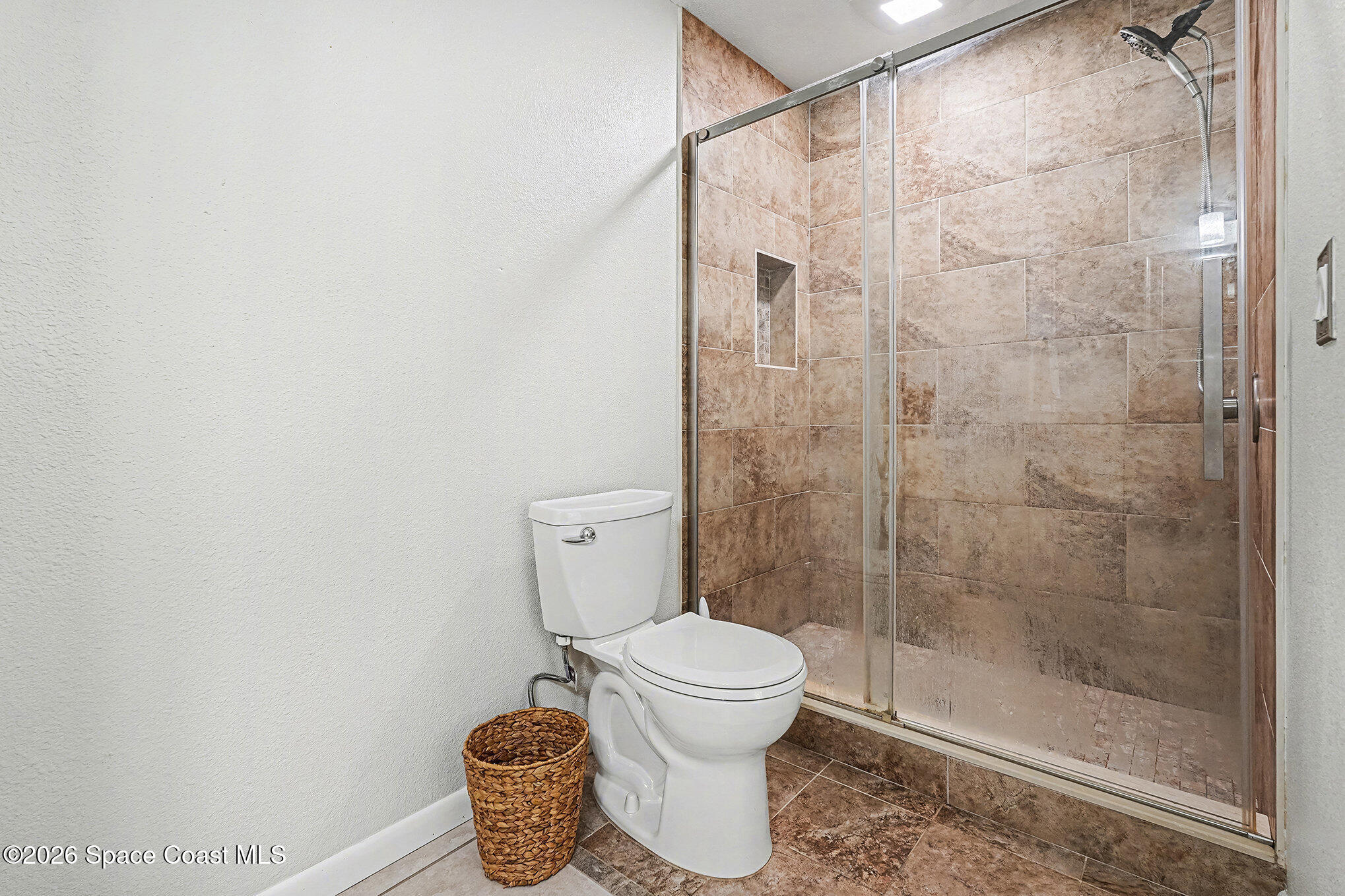 1491 Sheafe Avenue Northeast, Unit 104 Palm Bay, FL 32905 - Photo 7 of 19 a bathroom with a toilet and a shower
