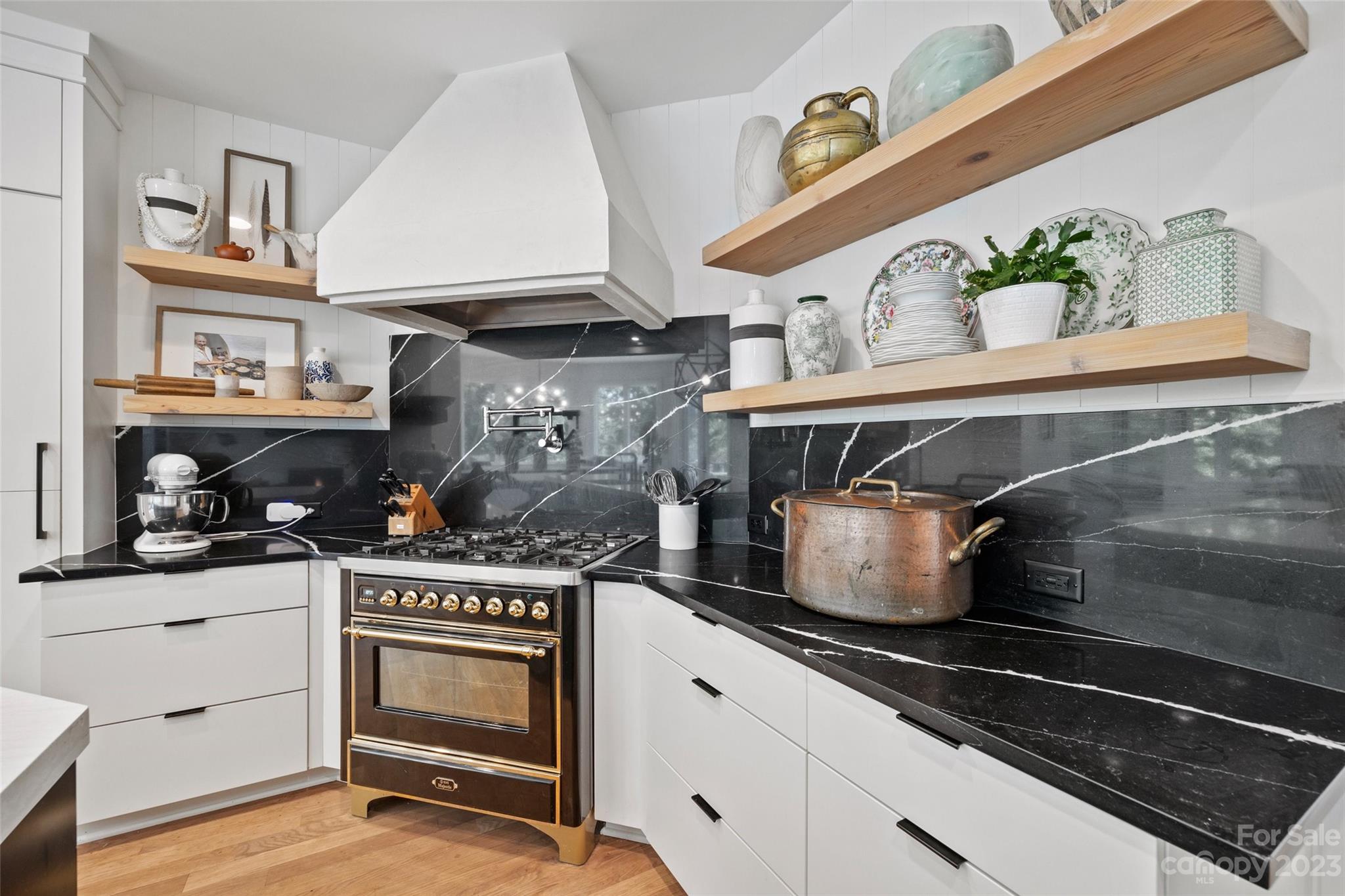 18930 Mary Ardrey Circle Cornelius, NC 28031 - Photo 14 of 48 a kitchen with stainless steel appliances granite countertop a stove and cabinets