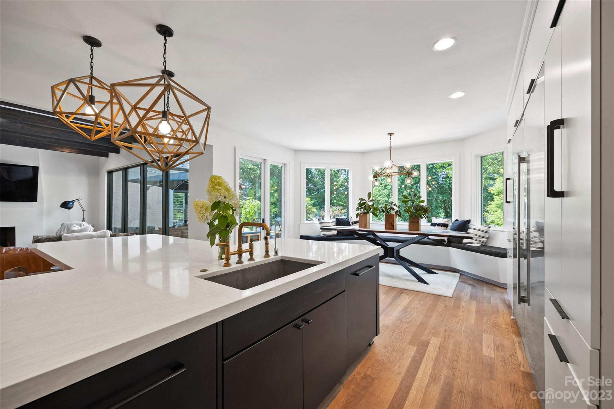 18930 Mary Ardrey Circle Cornelius, NC 28031 - Photo 15 of 48 a kitchen with sink cabinets and living room view