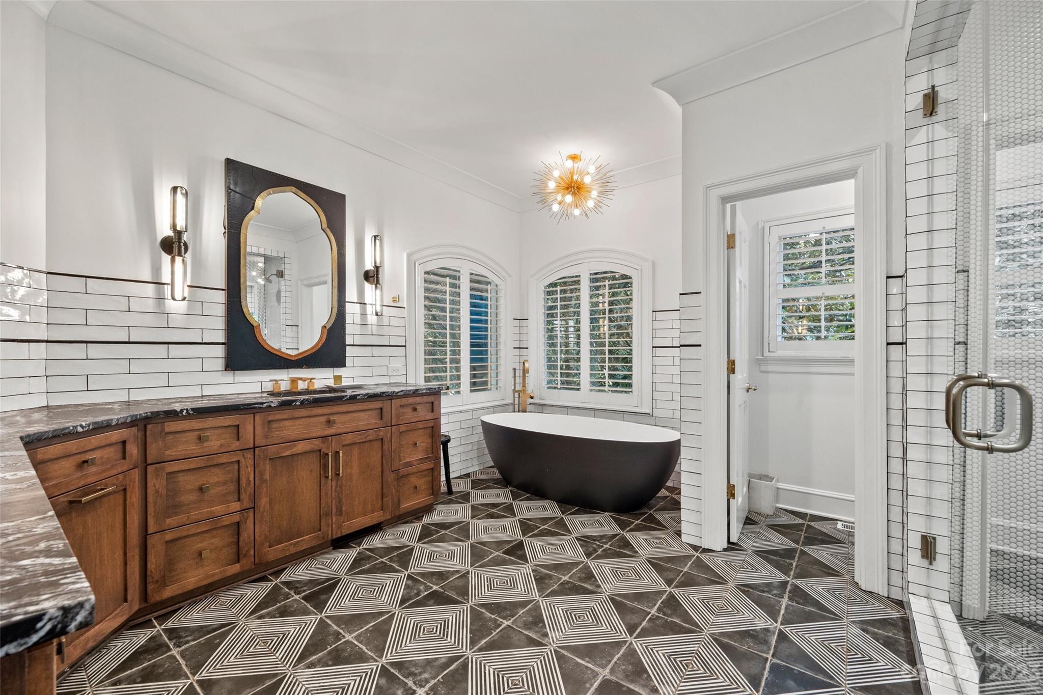 18930 Mary Ardrey Circle Cornelius, NC 28031 - Photo 20 of 48 a spacious bathroom with a granite countertop sink mirror and bathtub