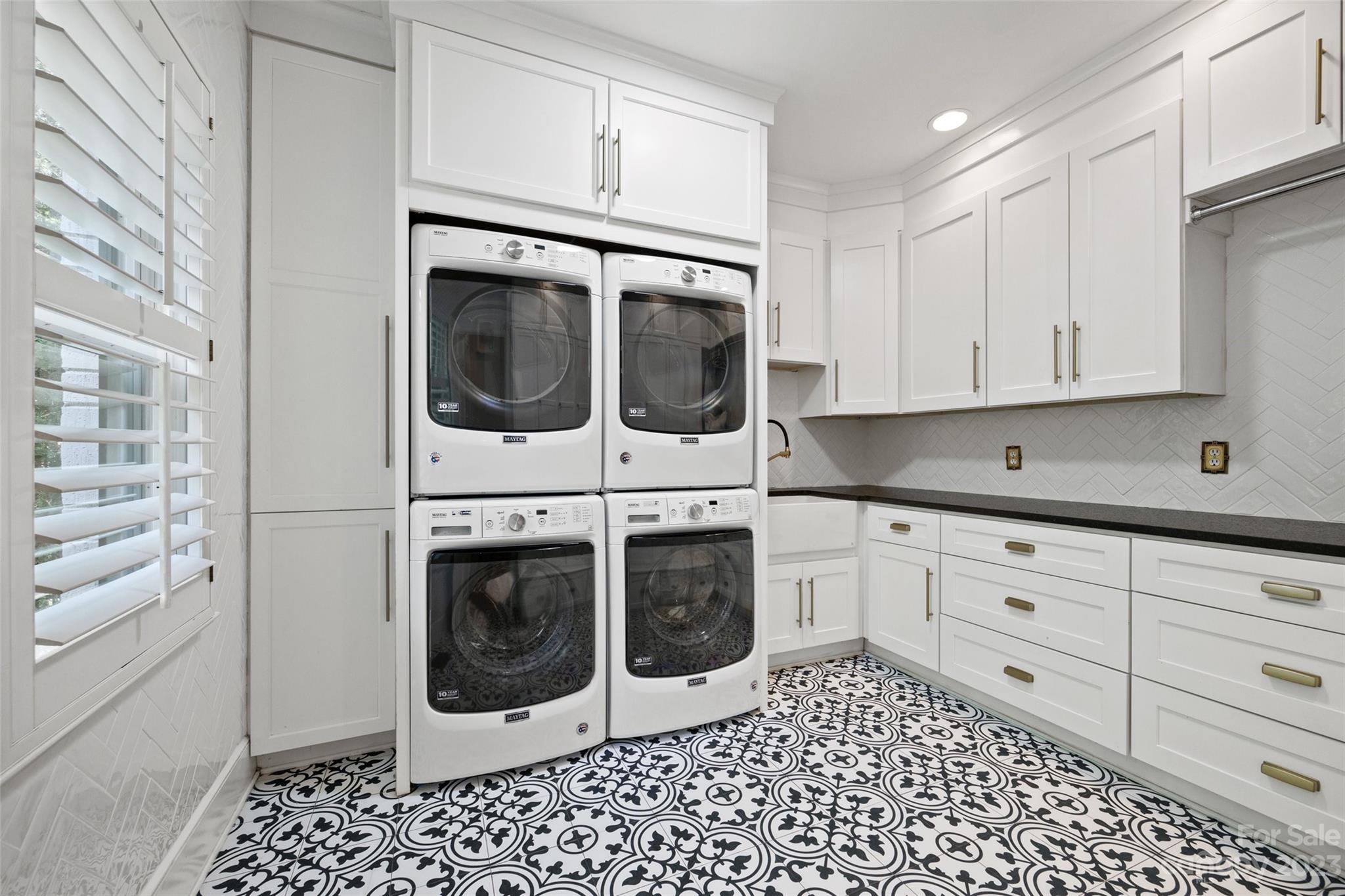 18930 Mary Ardrey Circle Cornelius, NC 28031 - Photo 22 of 48 a kitchen with granite countertop white cabinets and stainless steel appliances