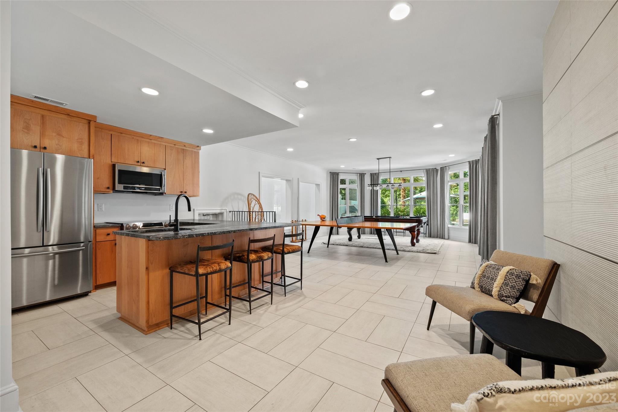 18930 Mary Ardrey Circle Cornelius, NC 28031 - Photo 34 of 48 a kitchen with stainless steel appliances kitchen island granite countertop a refrigerator and chairs