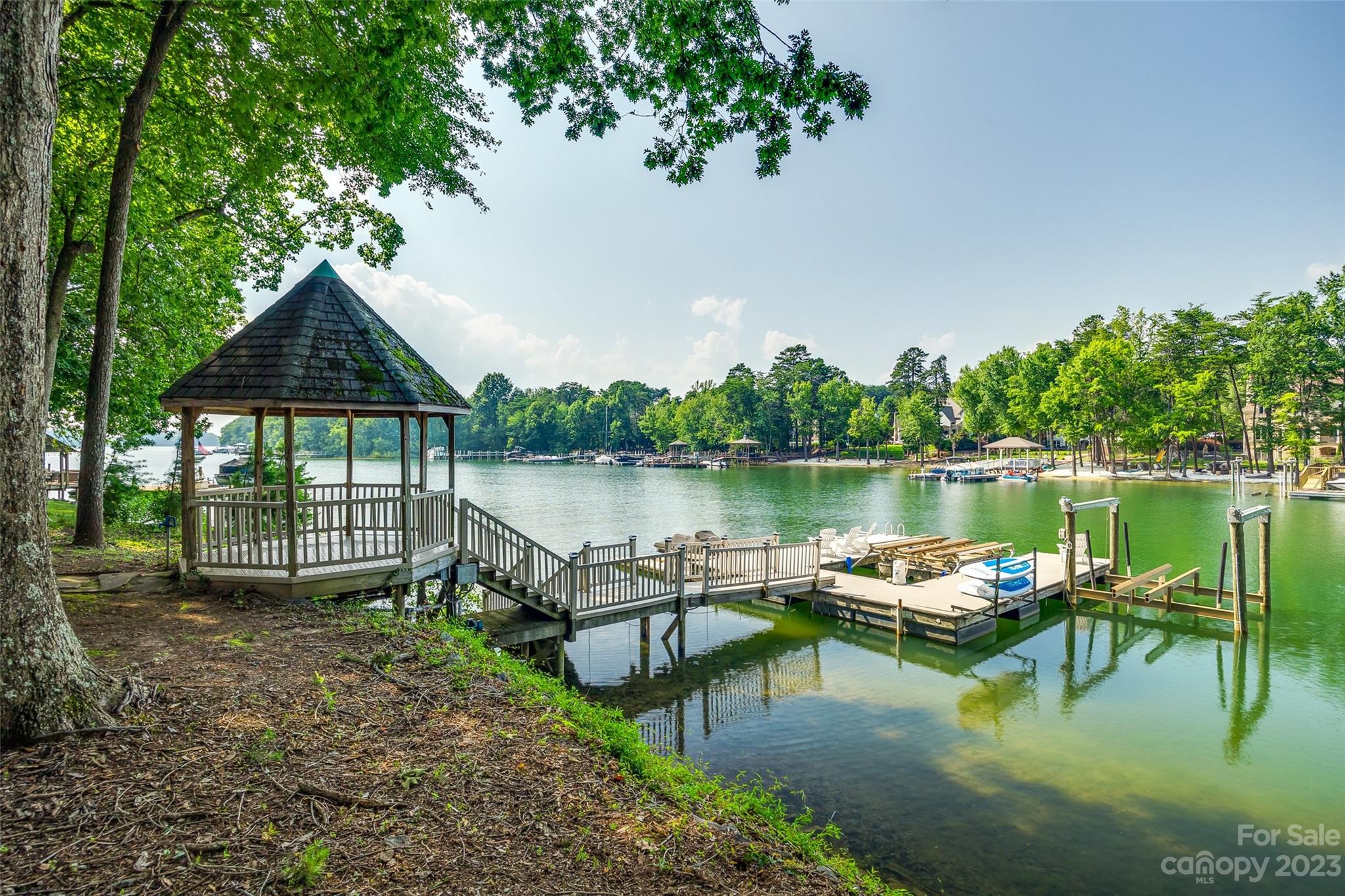 18930 Mary Ardrey Circle Cornelius, NC 28031 - Photo 45 of 48 a lake view with a bench next to a lake