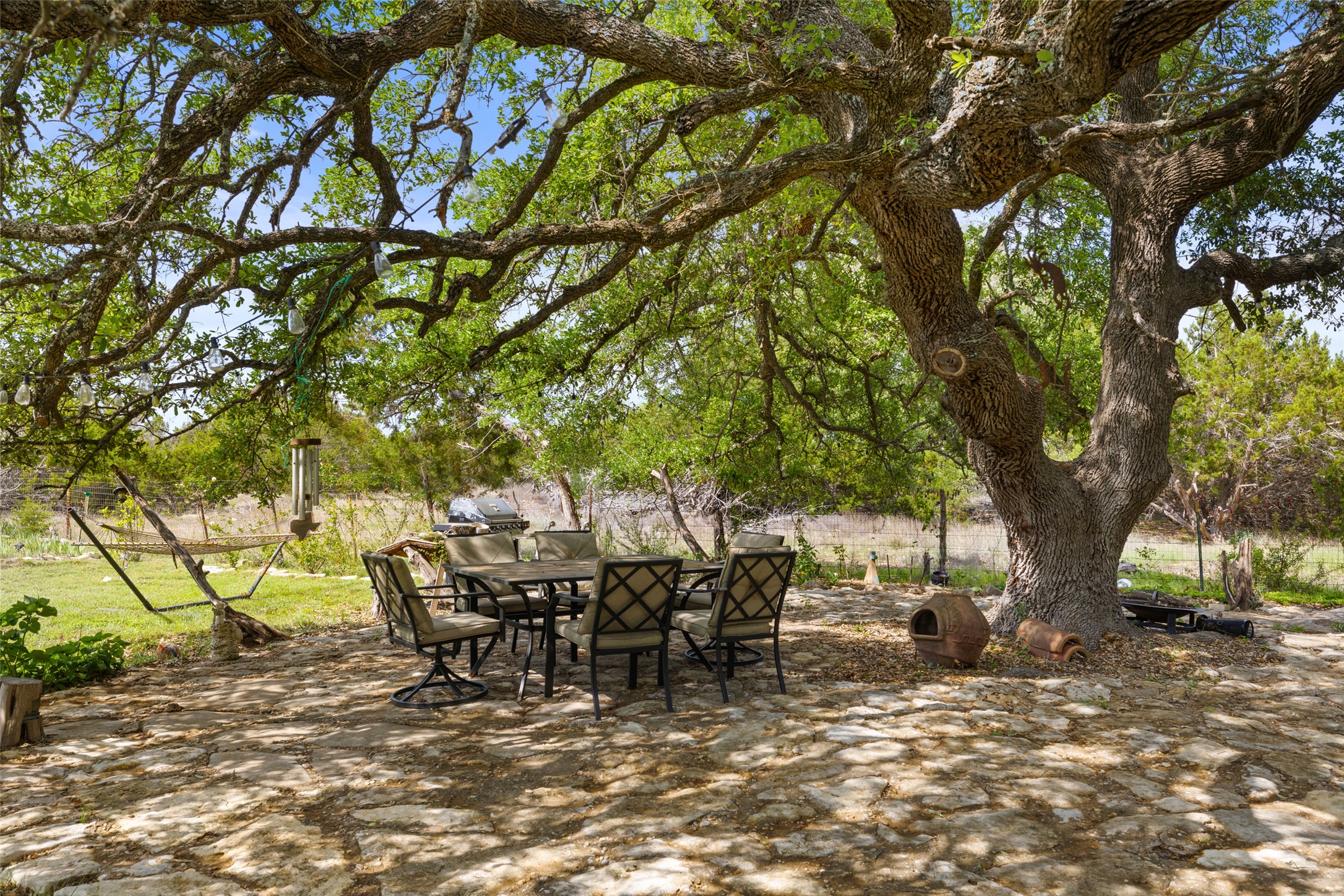 2966 Rm 165 Dripping Springs Dripping Springs, TX 78620 - Photo 10 of 23 Expansive outdoor patio featuring flagstone paving and shaded by a mature tree