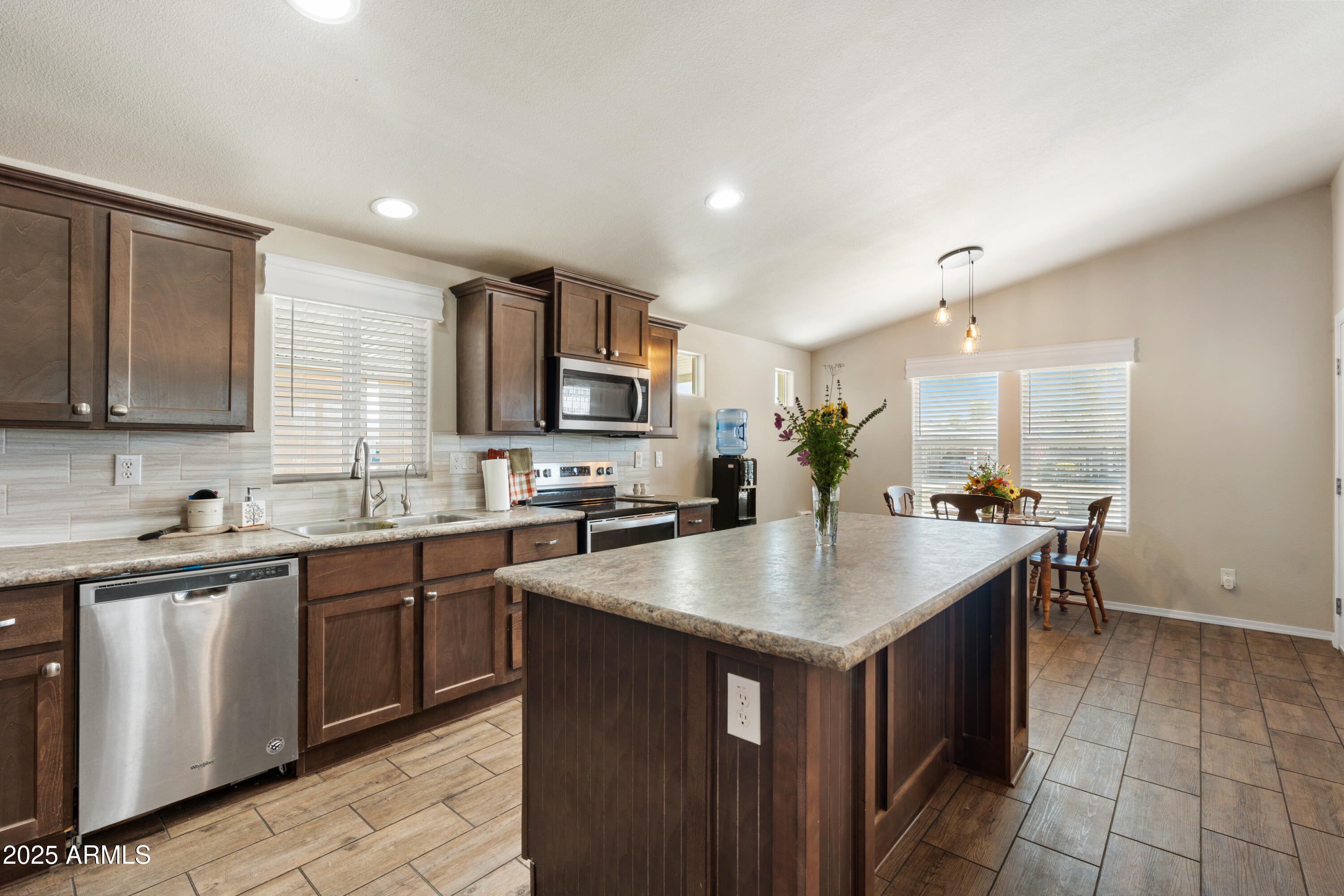 1174 Wheeler Road Camp Verde, AZ 86322 - Photo 13 of 23 a kitchen with kitchen island granite countertop a sink stove and cabinets