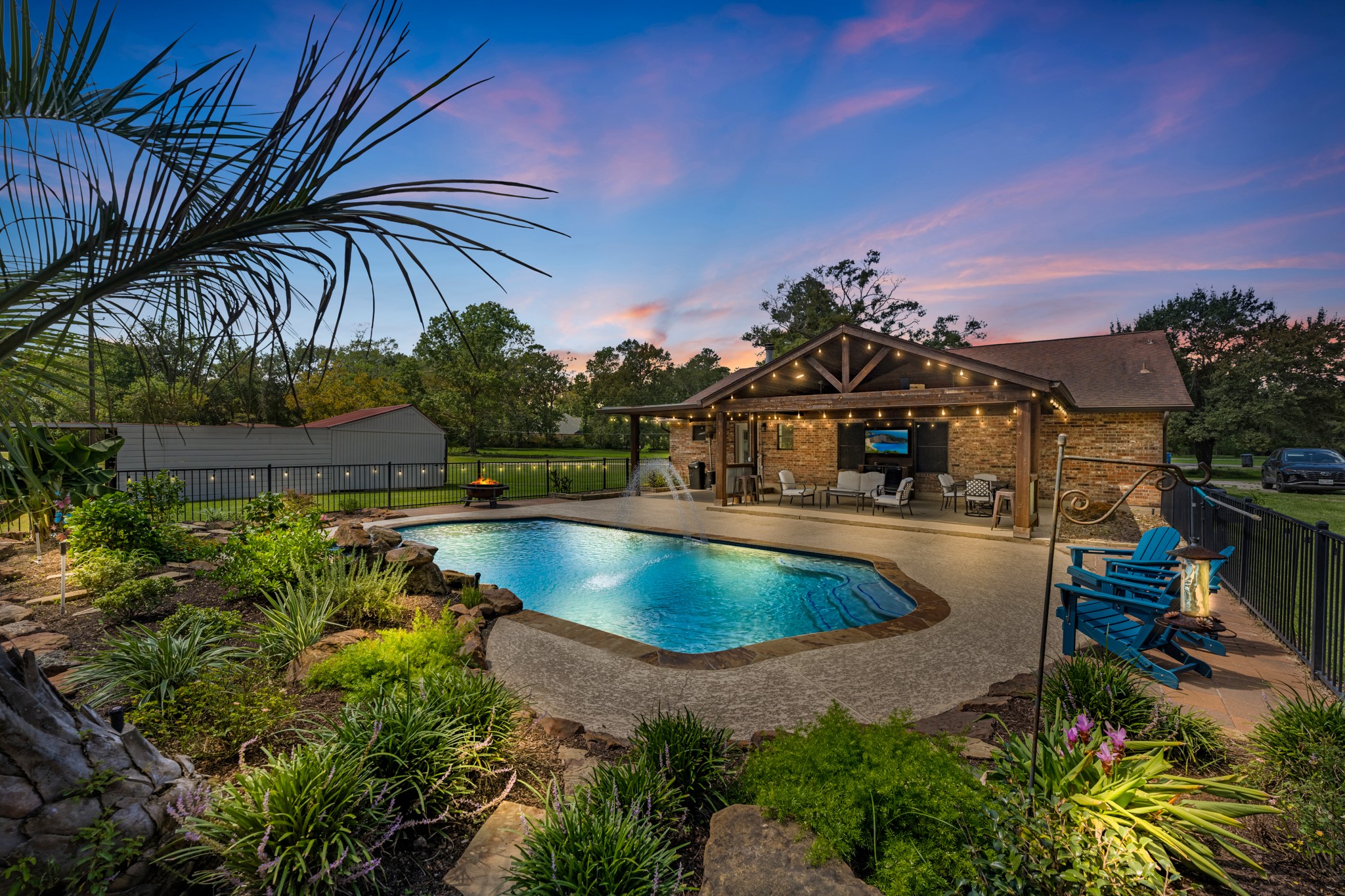 Private backyard retreat on 1.5 acres with sparkling pool, water features & lush landscaping!