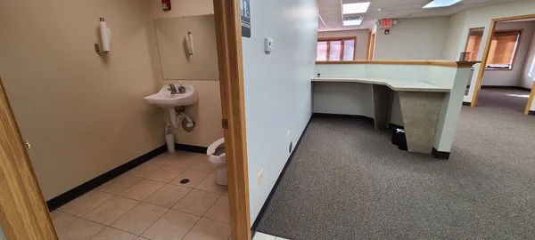a view of a hallway and a room with a fireplace