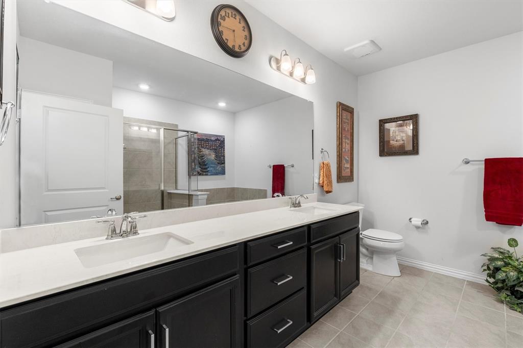 651 Watters Road, Unit 5205 Allen, TX 75013 - Photo 13 of 31 a bathroom with a double vanity sink and a toilet