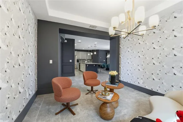 a large bedroom with a bed and a flat tv screen on dresser