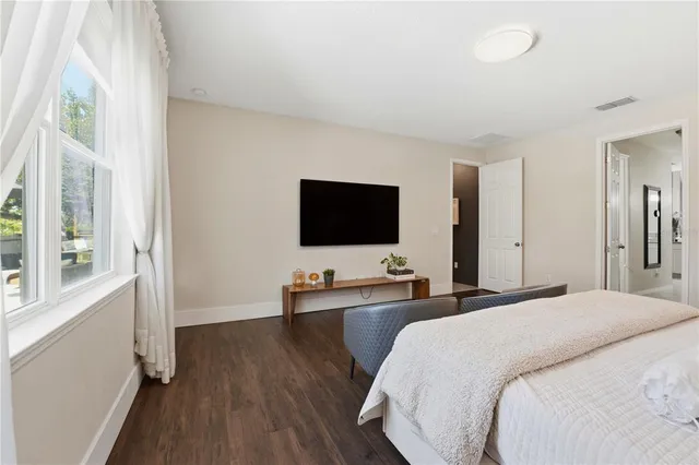 a living room with a wooden floor and a table