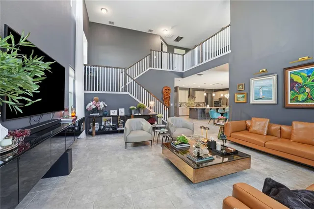 a living room with furniture potted plant and a flat screen tv