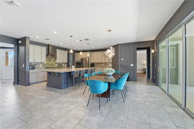 a kitchen with stainless steel appliances granite countertop a counter top space a sink refrigerator and cabinets