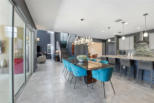 a kitchen with stainless steel appliances kitchen island granite countertop a sink stove and cabinets