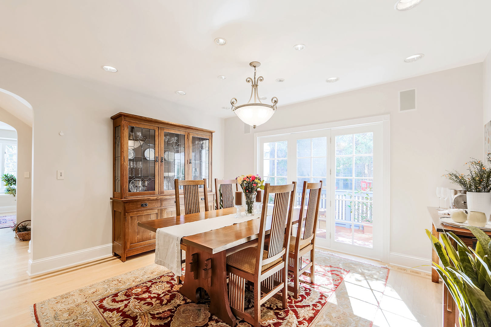 212 Stanley Avenue Park Ridge, IL 60068 - Photo 16 of 33 a dining room with wooden floor and a chandelier