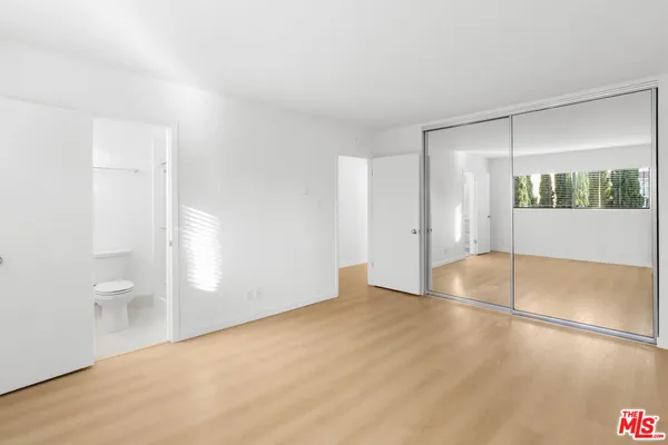 a white toilet sitting next to a shower