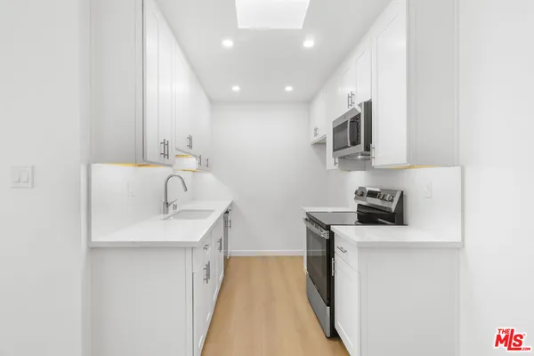a kitchen with a sink and cabinets