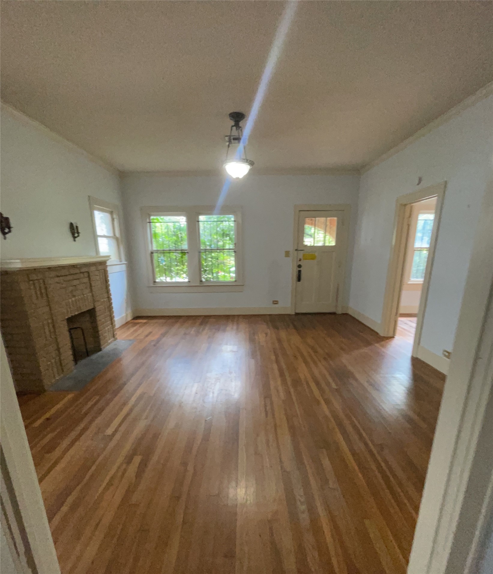 4716 Crawford Street Houston, TX 77004 - Photo 3 of 14 an empty room with wooden floor and windows