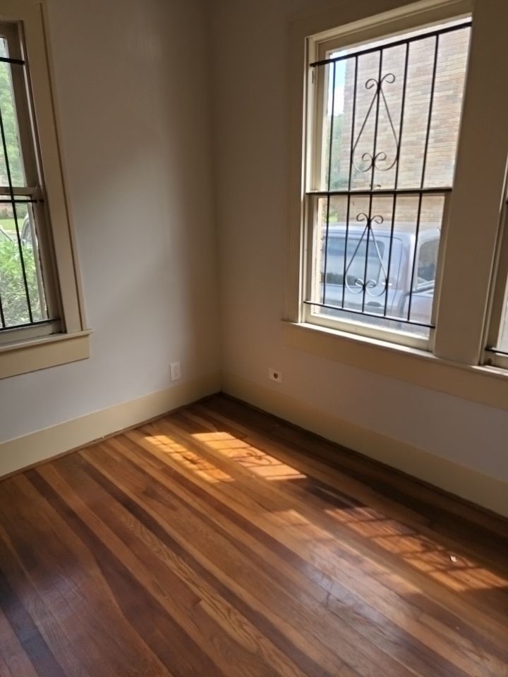 4716 Crawford Street Houston, TX 77004 - Photo 10 of 14 a view of empty room with wooden floor and fan