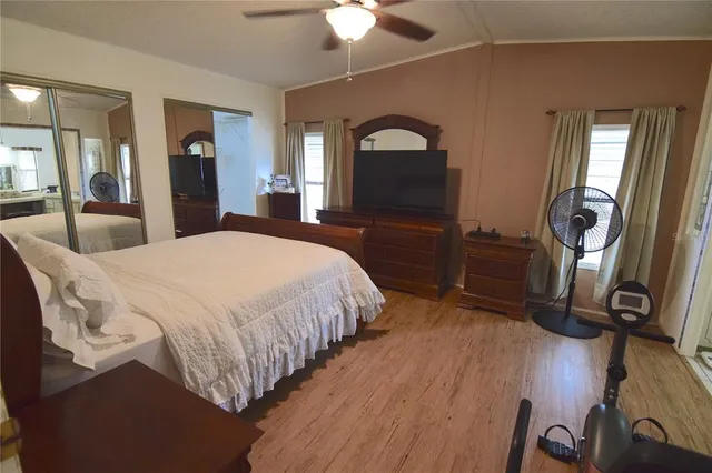 a bedroom with a bed and a mirror