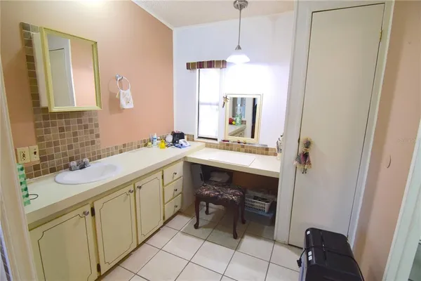 a spacious bathroom with a double vanity sink a mirror and a bathtub