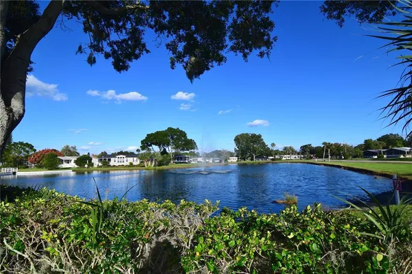 a view of a lake with houses in the back
