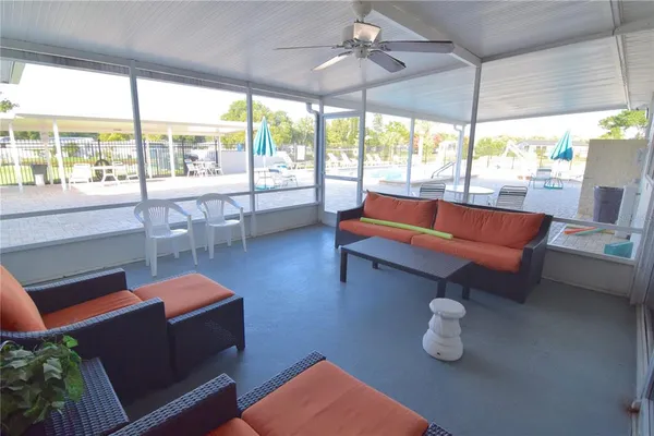 a swimming pool with outdoor seating and yard