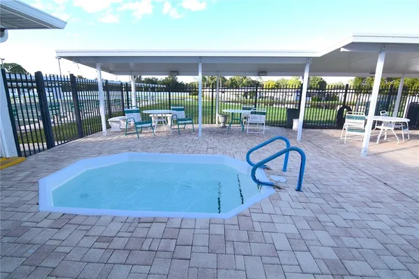 a view of swimming pool with outdoor seating
