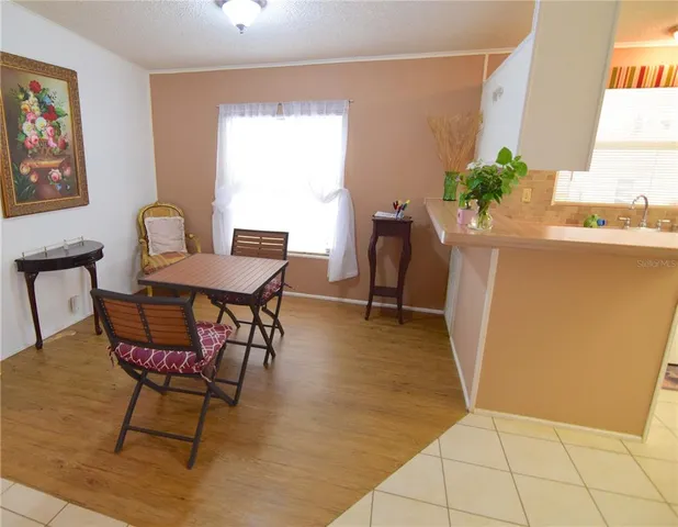 a view of a dining room with furniture and a potted plant