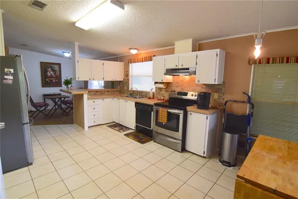 a kitchen with stainless steel appliances a stove a sink and a refrigerator
