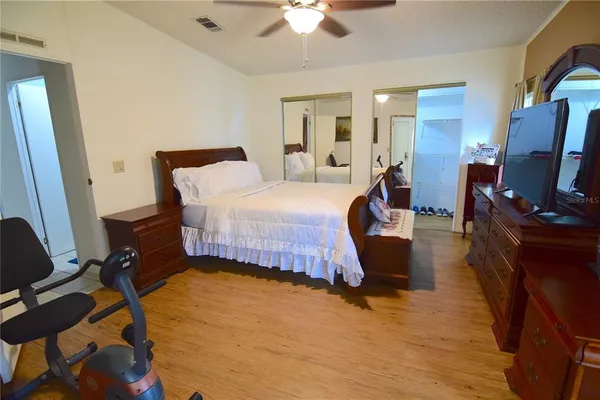 a bed room with a bed window and a chair