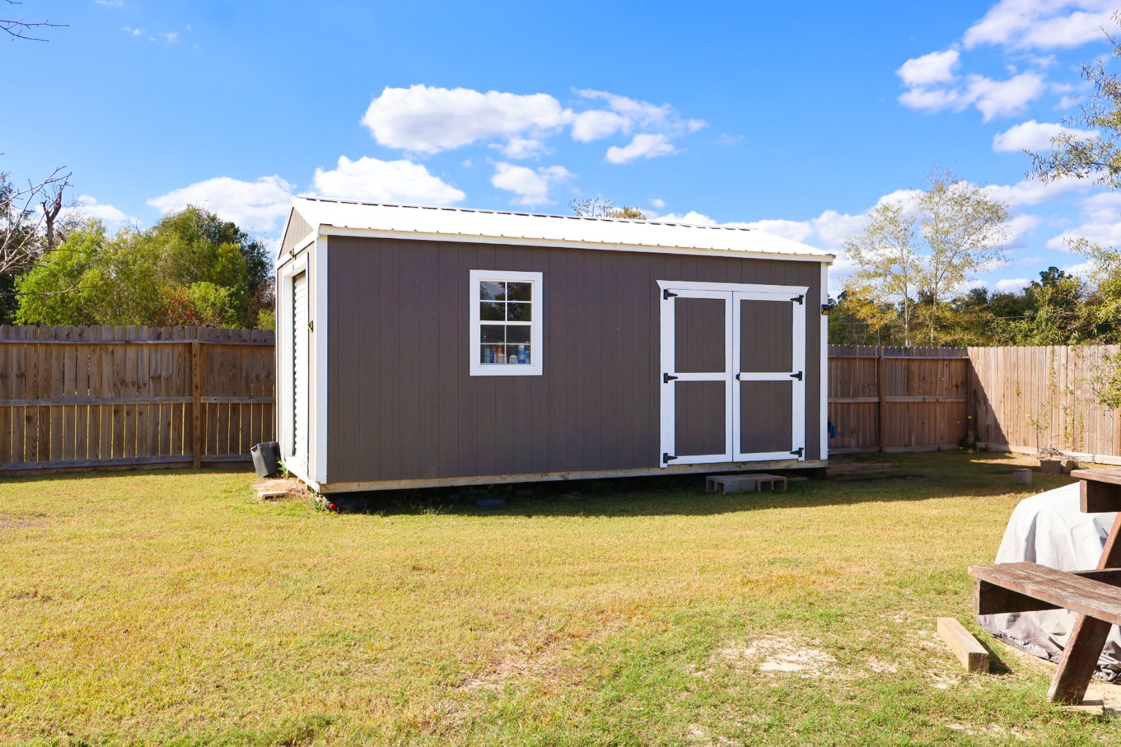 21625 County Road 3749D Cleveland, TX 77327 - Photo 17 of 20 a view of a backyard with a small cabin