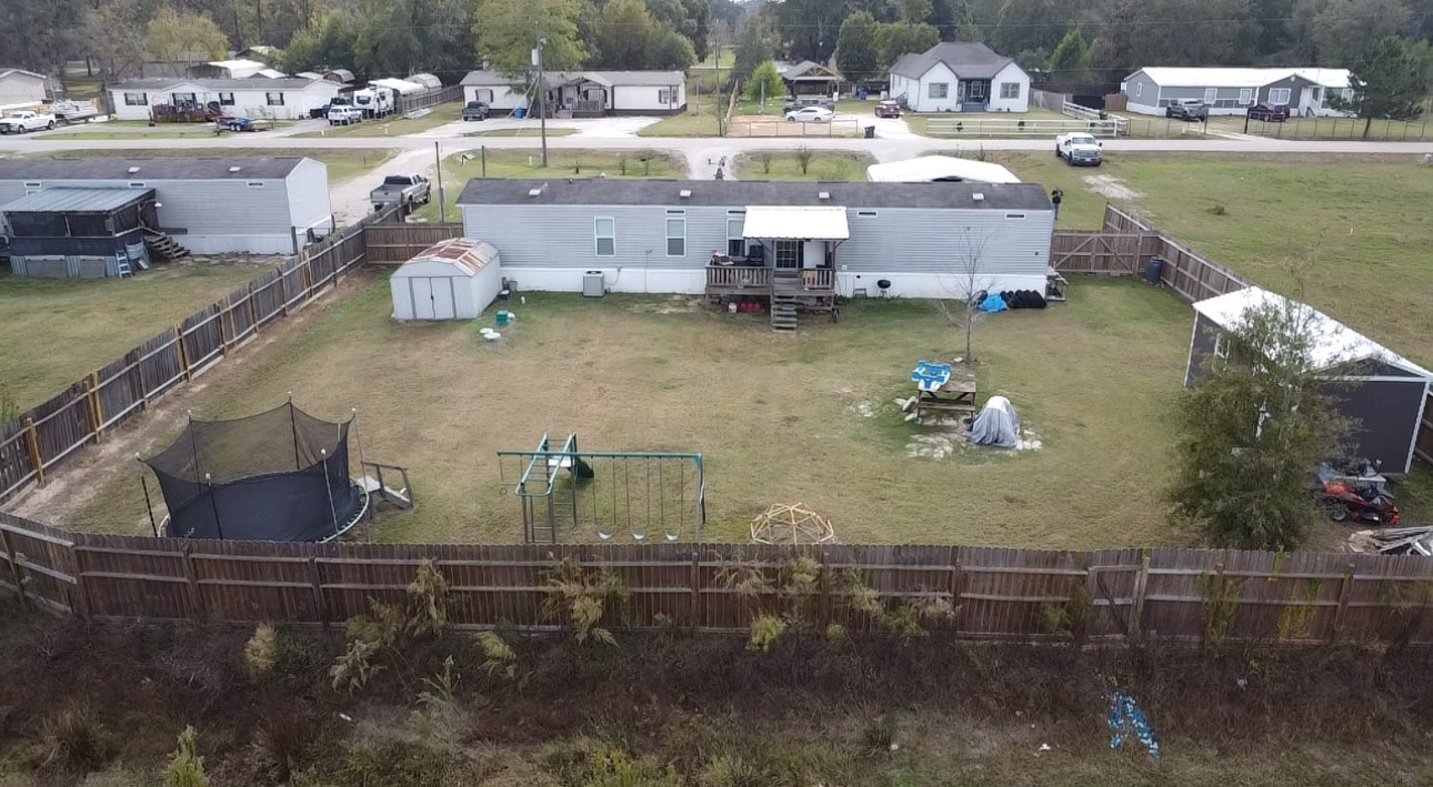 21625 County Road 3749D Cleveland, TX 77327 - Photo 20 of 20 a aerial view of a house with a lake view