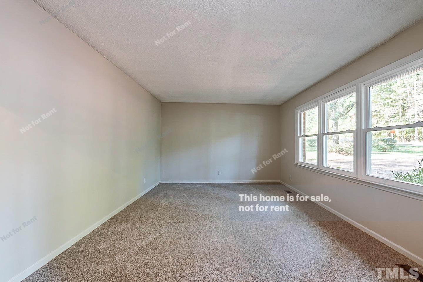 4903 Fayetteville Road Durham, NC 27713 - Photo 12 of 19 an empty room with a empty space and windows
