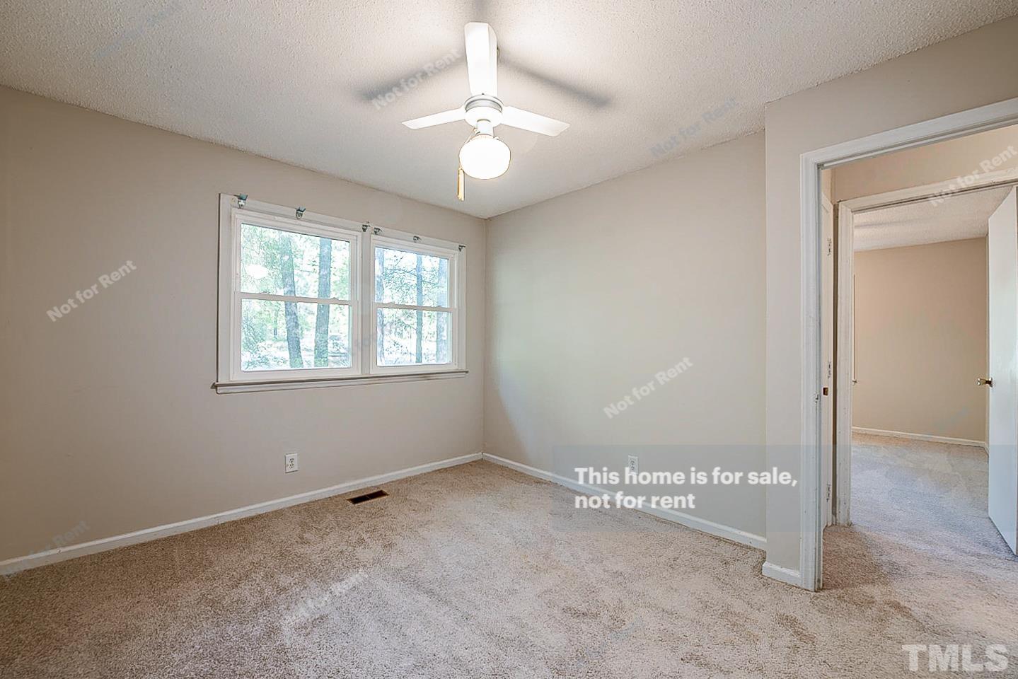4903 Fayetteville Road Durham, NC 27713 - Photo 13 of 19 an empty room with windows and chandelier fan